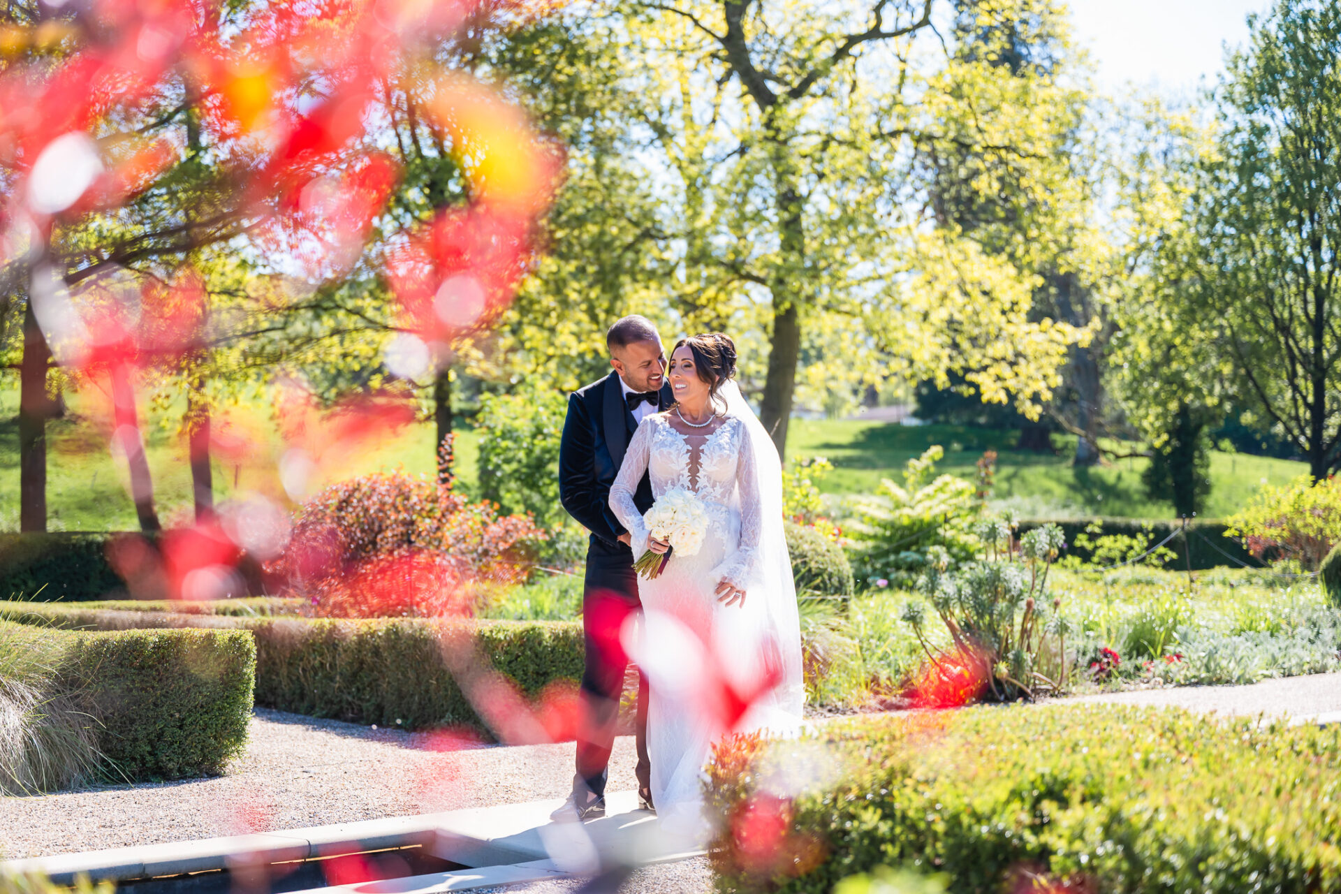 Bride and groom posing in the immaculate Grantley Hall Gardens, luxury wedding photographer.