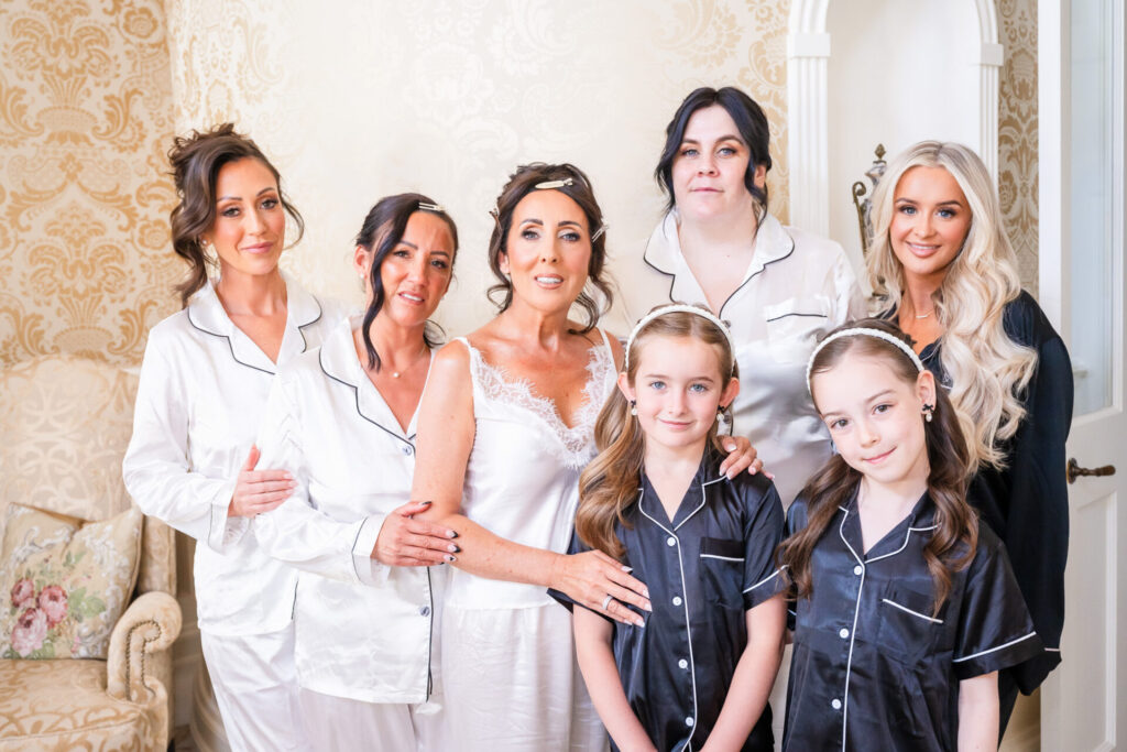 bridal party posing for image in there wedding pyjamas , The Royal Suite , Grantley Hall