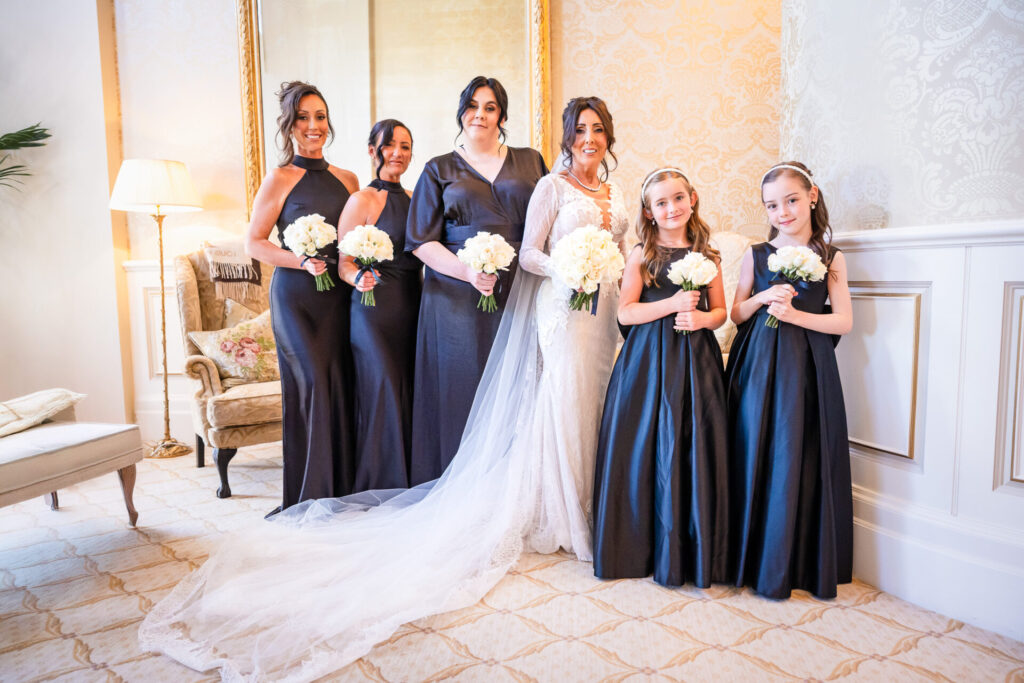 The whole bridal party posing for a picture just before the ceremony in the Royal suite at Grantley Hall