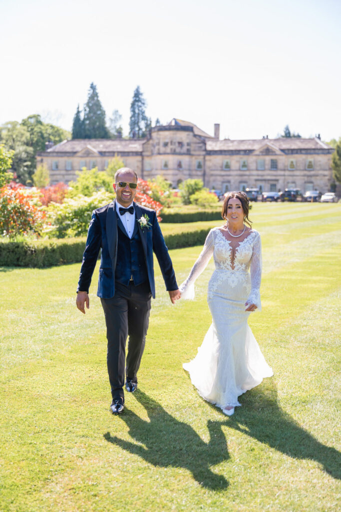 Bride and Groom Walking the lawns of Grantley Hall