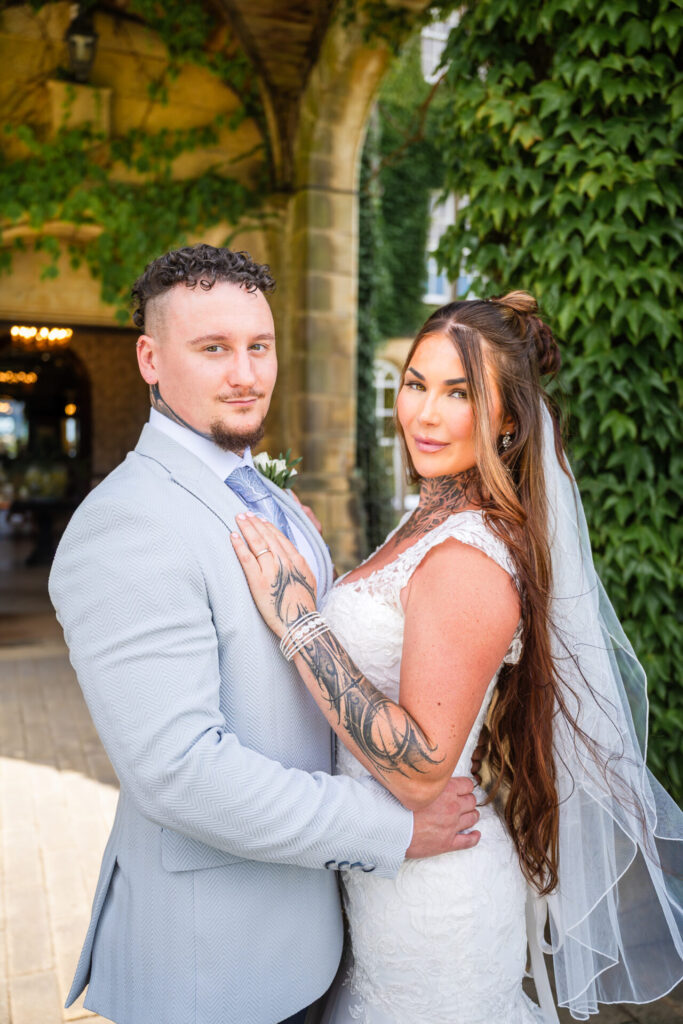 Bride and groom portrait outside the main entrance of Swinton Park Estate Hotel, North Yorkshire wedding photographer.